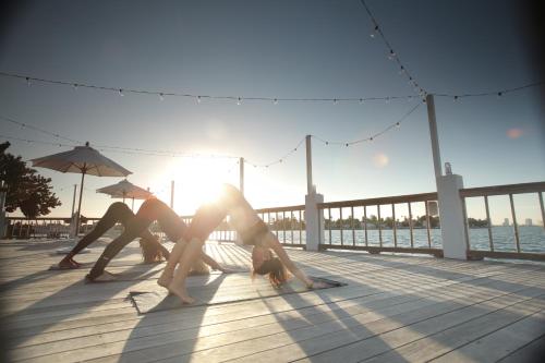 two women are laying on a pier near the water at The Standard Miami in Miami Beach