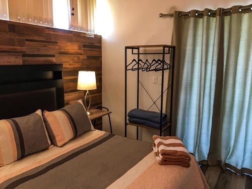 a bedroom with a large bed and a chair at Casa Bravía - Hotel·RV in San Luis Soyatlán