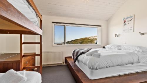 a bedroom with two beds and a bunk bed at Lawlers 6 in Mount Hotham