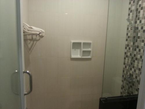 a bathroom with a shower with a glass door at New ASTA GRAHA GUESTHOUSE in Jimbaran