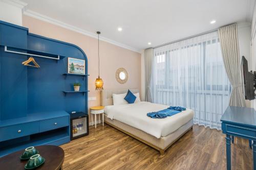 a bedroom with a bed and a large window at Santori Hotel And Spa in Da Nang