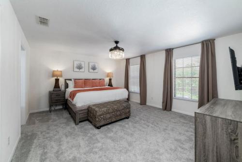 a large bedroom with a bed and a window at Romantic forest view 5BR Minutes to Disney in Kissimmee