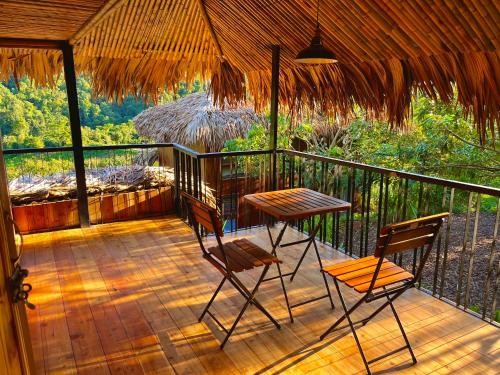a balcony with a table and two chairs on it at Mường Sang Retreat in Mộc Châu