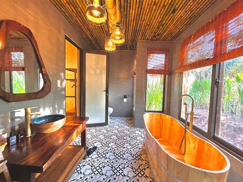 木州的住宿－Mường Sang Retreat，一间带大浴缸和水槽的浴室