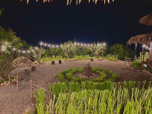 a garden at night with lights in the background at Mường Sang Retreat in Mộc Châu