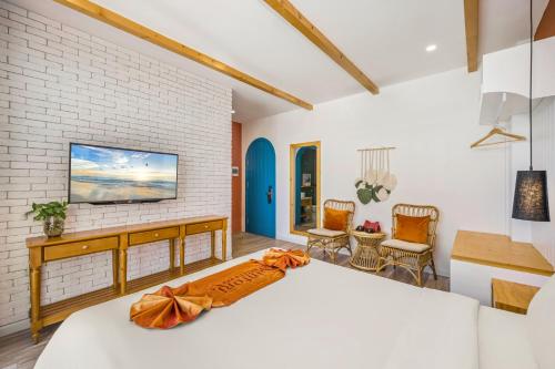 a bedroom with a bed and a tv on a brick wall at Santori Hotel And Spa in Da Nang