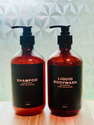 two bottles of liquid laundry detergent sitting next to each other at Hidden of Cailan Inn in El Nido