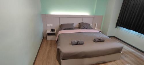a bedroom with a bed with two pillows on it at Sritrang Residence in Ban Khlong Wa