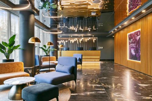 a lobby with chairs and a waiting room at Melbourne City Apartment Hotel in Melbourne