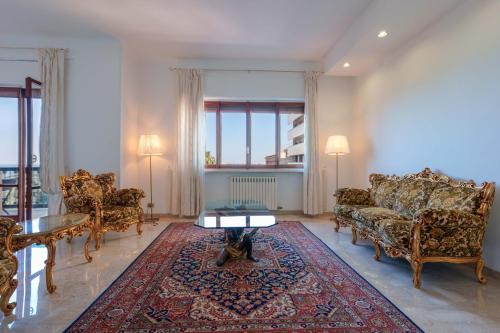 a living room with a couch and chairs and a table at Ai Marinai in Taranto