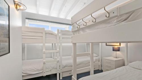 a bedroom with two bunk beds and a window at Razorback 6 in Mount Hotham