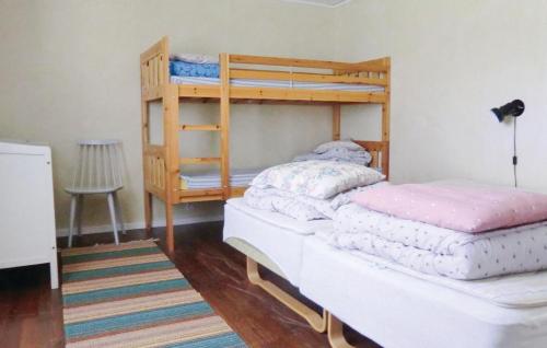 a bedroom with two bunk beds and a ladder at Holiday Home Möllstorpsgatan Färjestaden Ii in Färjestaden