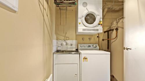 a small kitchen with a refrigerator and a microwave at Razorback 7 in Mount Hotham