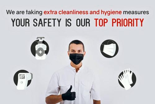 a man wearing a black face mask with the words we are taking extra cleanliness at Maikhao Beach Residence in Mai Khao Beach