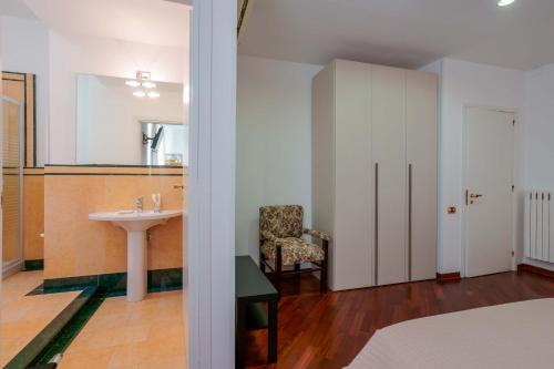 a bathroom with a sink and a chair and a mirror at Ai Marinai in Taranto
