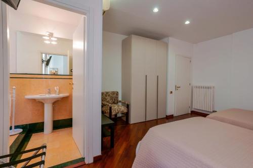 a bedroom with a bed and a sink and a mirror at Ai Marinai in Taranto