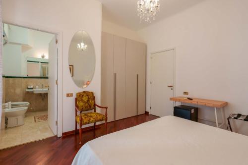 a bedroom with a bed and a chair and a bathroom at Ai Marinai in Taranto