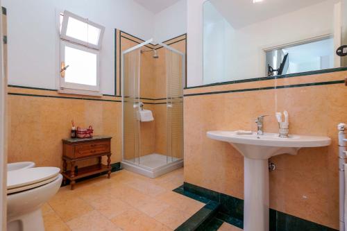 a bathroom with a toilet and a sink and a shower at Ai Marinai in Taranto