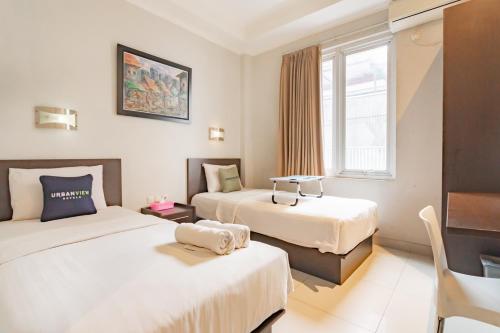 Postel nebo postele na pokoji v ubytování Urbanview Hotel Grand Malabar Bandung