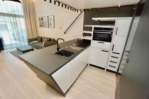 a kitchen with a sink and a counter top at Chalet Park by Maier Mäder in Mäder