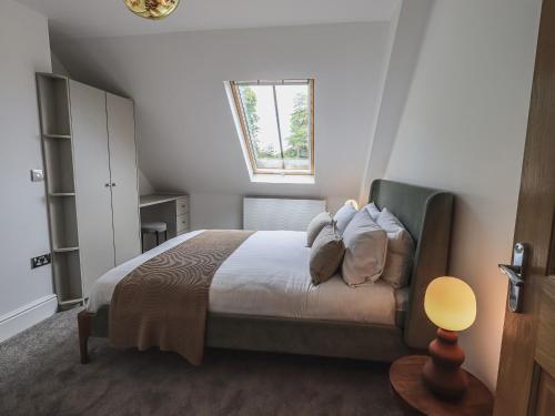 A bed or beds in a room at The Mabel Suite Stone Cross Mansion