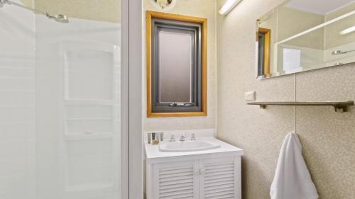 a bathroom with a sink and a mirror at Snowtel 1 in Mount Hotham