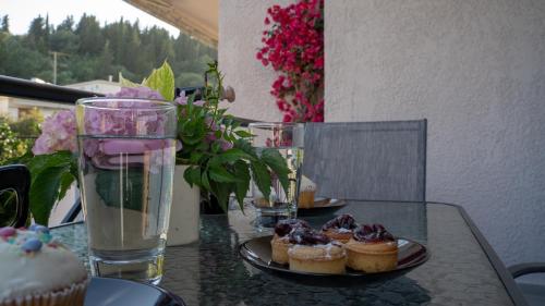 a table with cupcakes and a plate of cupcakes on it at Sivotahomes-family in Sivota