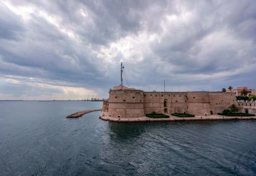 a castle in the middle of a body of water at Ai Marinai in Taranto