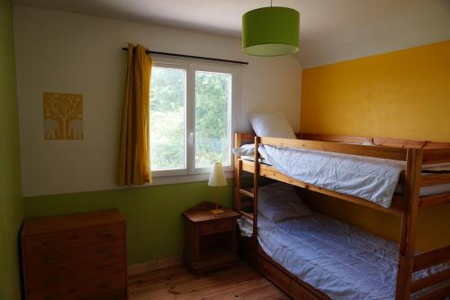 um quarto com 2 beliches e uma janela em Maison champêtre et joyeuse à la campagne em Berenx