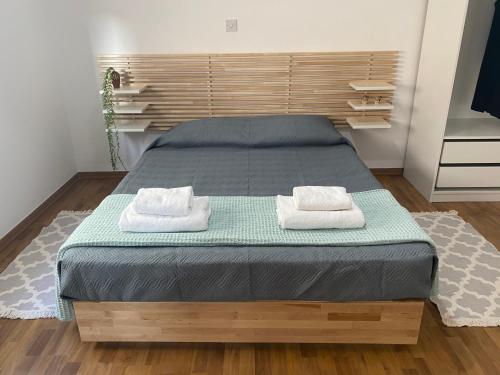 a bedroom with a bed with two towels on it at Lovely studio apartment in Pafos in Paphos City