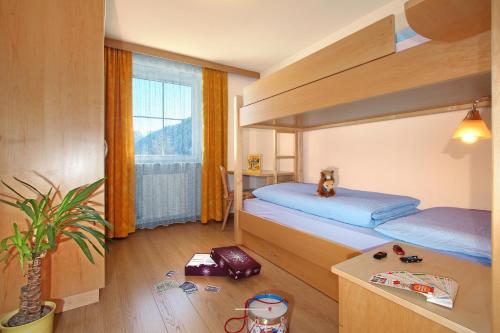 a bedroom with two bunk beds and a potted plant at Wurzerhof in Racines