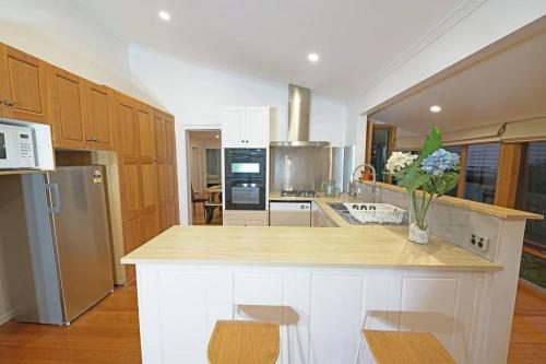 a kitchen with a counter with two chairs in it at Vermont 8 Bdrm Holiday Entire House for Big Group in Vermont