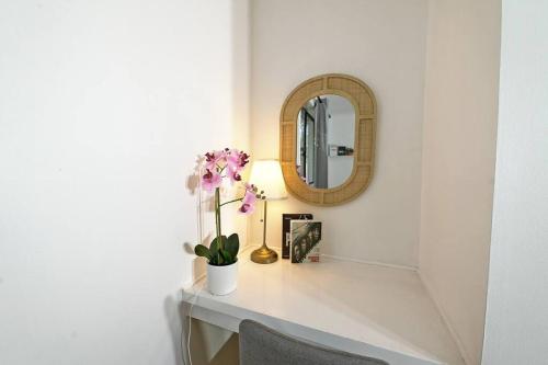 a white counter with a mirror and flowers on it at Vermont 8 Bdrm Holiday Entire House for Big Group in Vermont