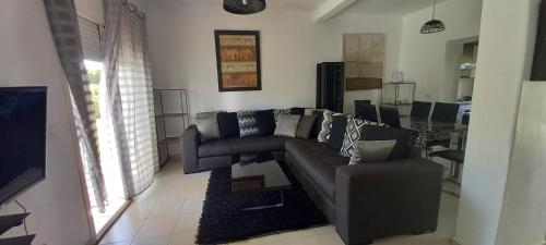 a living room with a couch and a table at Magnifique Villa Al Cudia Smir vue Mer Fnideq / Mdiq in Fnidek