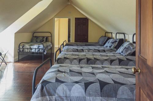 two beds in a room with a attic at CLAYFIELD HOMESTEAD - rustic country accommodation in Bishopsbourne