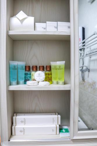a shelf with books and other items in a refrigerator at 36Manor International Sport Hotel in Vientiane