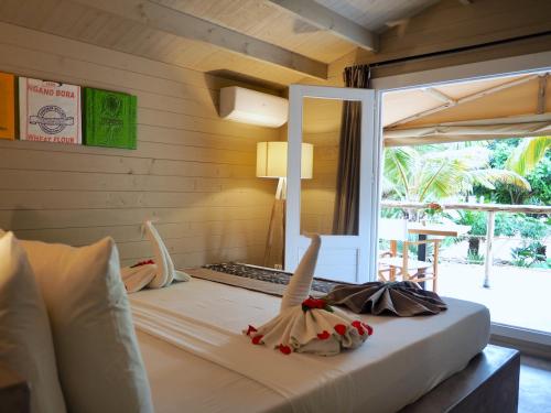 a bedroom with a bed with a view of a patio at Mwezi Boutique Resort in Jambiani