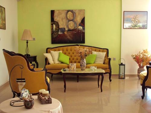 a living room with a couch and a table at Castellania Hotel Apartments in Livadia
