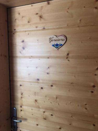 a wooden door with a heart on it at El Malget in Tuenno
