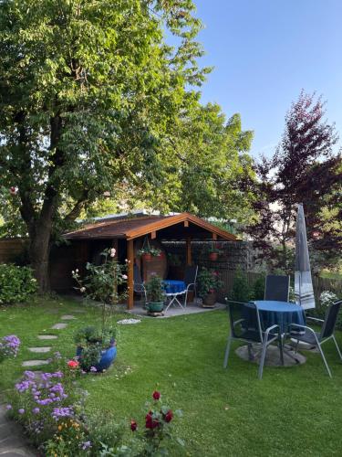 a gazebo with a table and chairs in a yard at Ferienwohnungen Gmeiner in Bad Endorf