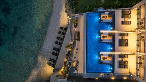 an overhead view of a swimming pool at night at SEA ZANTE Luxury Beachfront Retreat in Tragaki