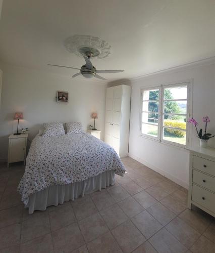 une chambre blanche avec un lit et une fenêtre dans l'établissement La veranda, à Yviers