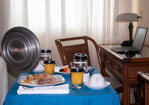 a blue table with a plate of food on it at Radisson Colon 2,000 Hotel & Casino in Colón