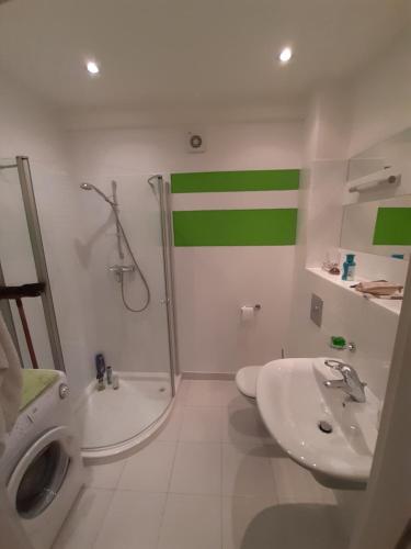 a bathroom with a shower and a sink and a toilet at Apartament Paderewski in Oleśnica
