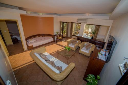 an aerial view of a living room with a couch and chairs at AUX ROCHES ROUGES in Mahajanga