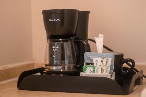 a coffee maker sitting on top of a table at Radisson Colon 2,000 Hotel & Casino in Colón
