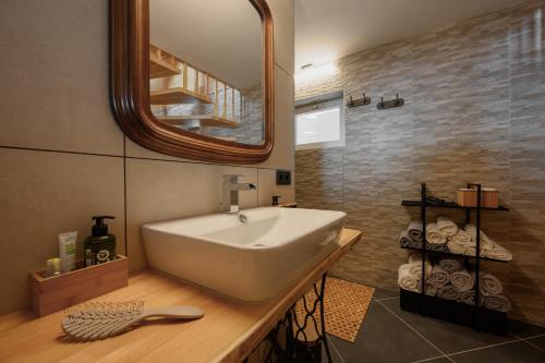 a bathroom with a white sink and a mirror at Bergspektive - Haus Alpenspa in Rieding