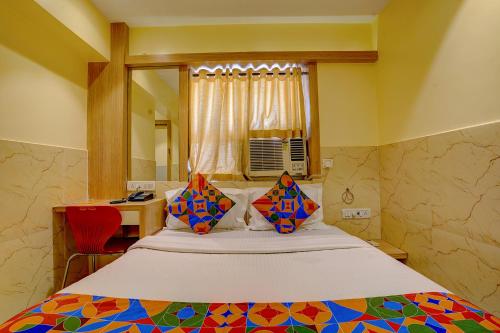 a bedroom with a large bed with a mirror at FabHotel Starwood Residency in Navi Mumbai
