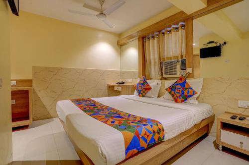 a bedroom with a large bed in a room at FabHotel Starwood Residency in Navi Mumbai