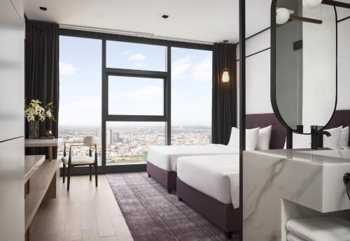 Postel nebo postele na pokoji v ubytování Citadines Flatiron Phnom Penh